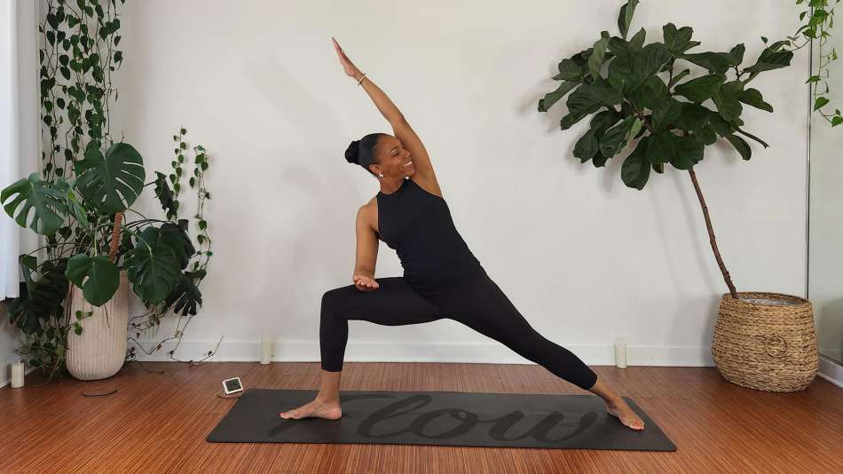 Georgette Dunn doing a lunge on a dark yoga mat