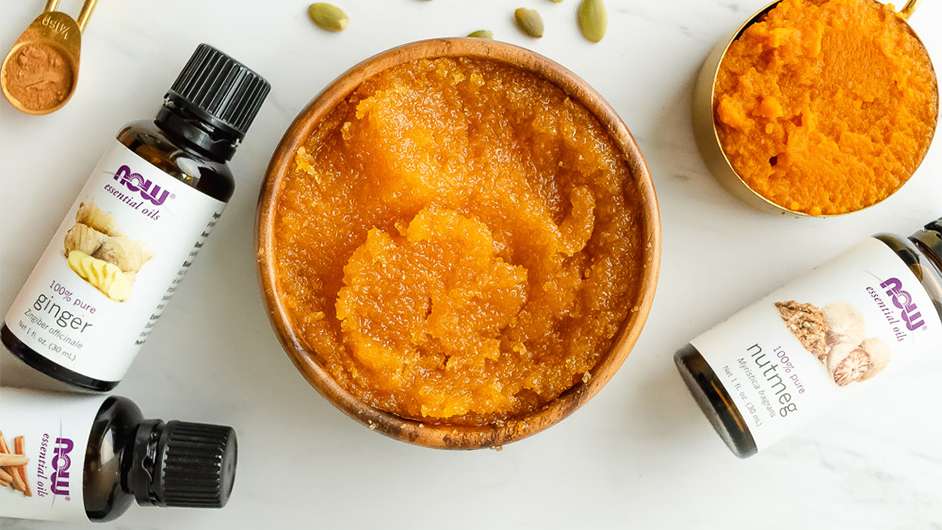 top view of pumpkin puree and various NOW Essential oils on a white background