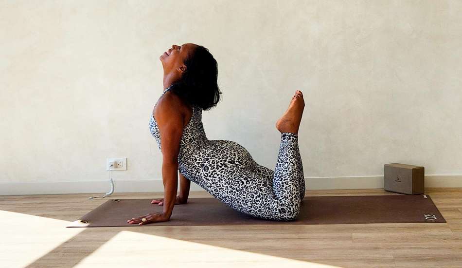 dark skinned female presenting person doing yoga 