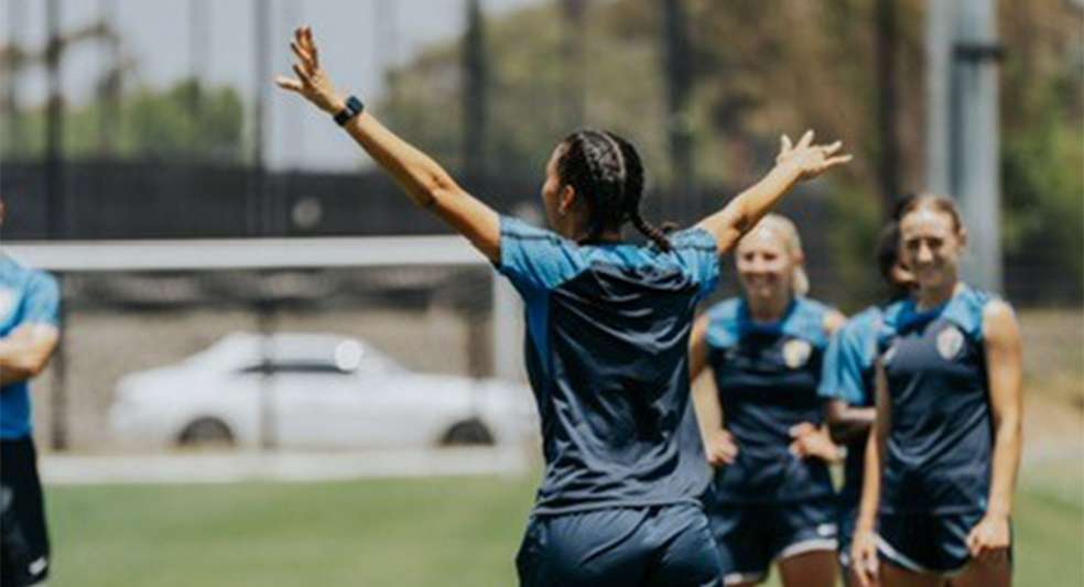 Estelle Johnson walking with her hands in the air celebrating